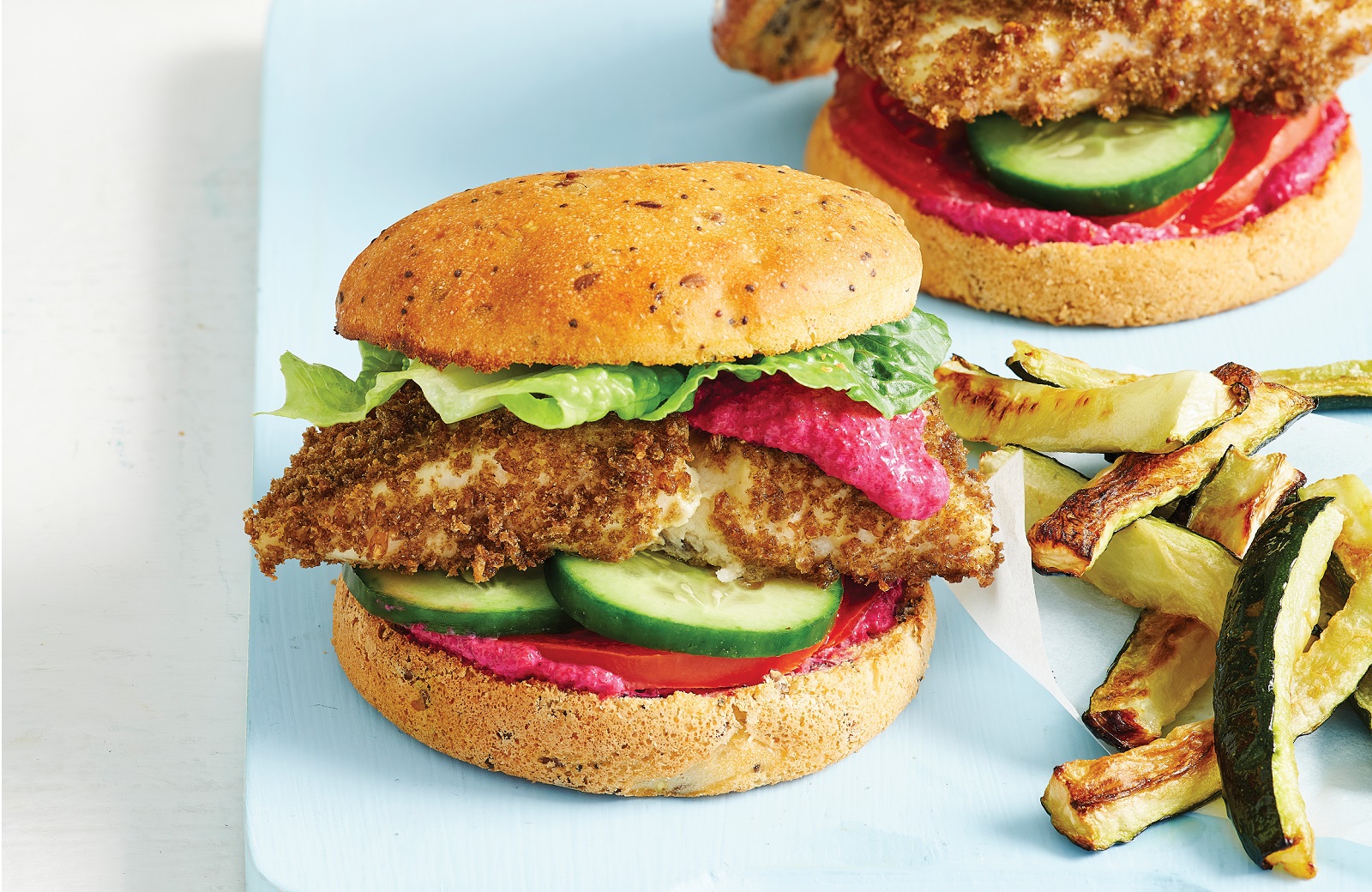 Crumbed fish fillet burgers with beetroot sauce